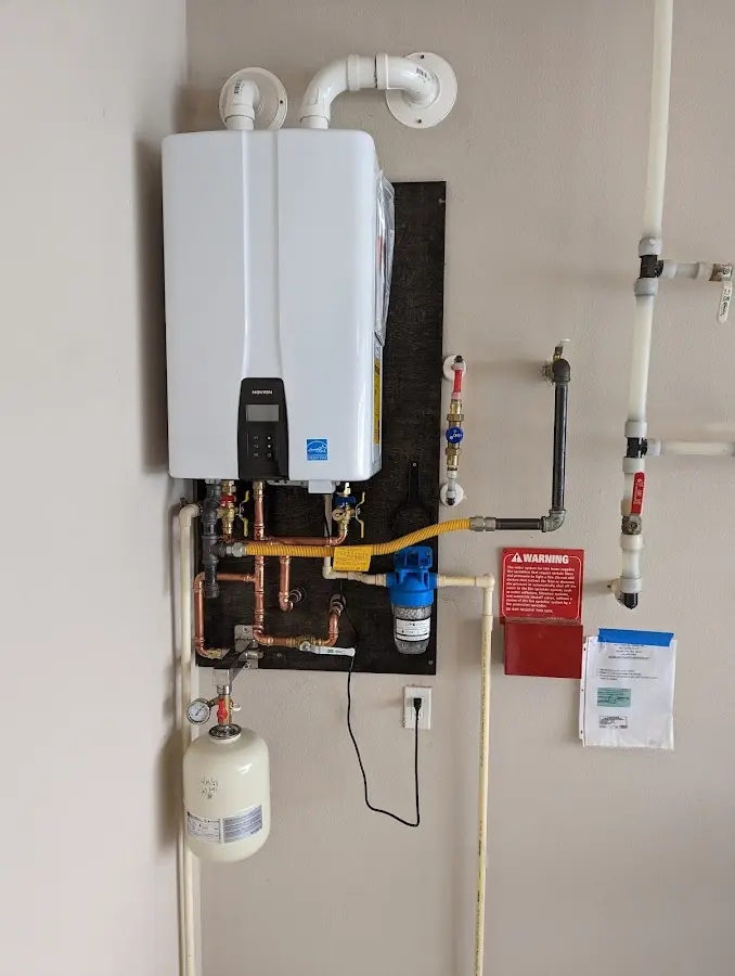 Professional plumber installing copper piping in a Cambridge home